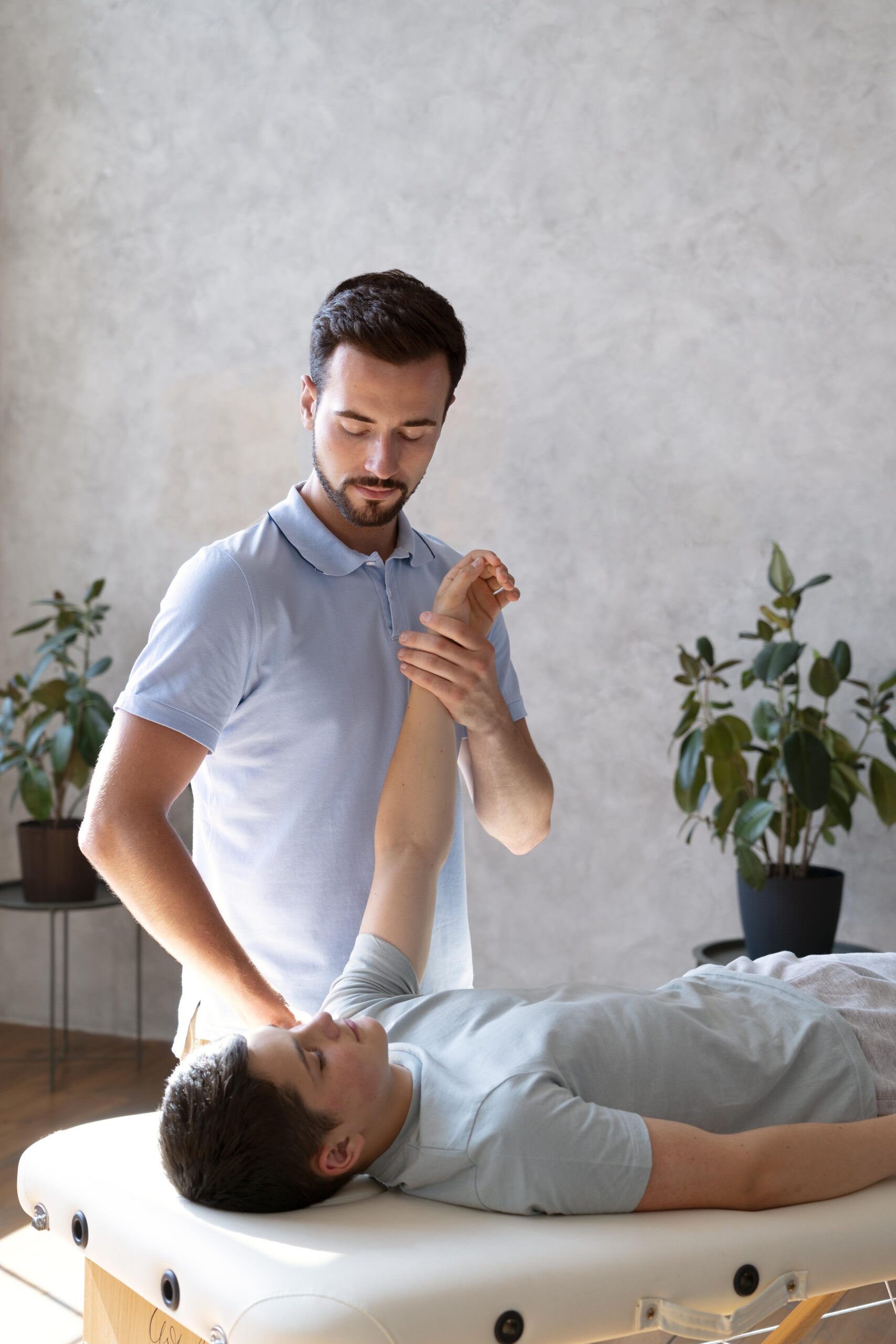 medium-shot-physiotherapist-checking-arm